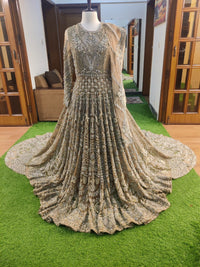 Elegant beaded gown on a mannequin against a home interior background